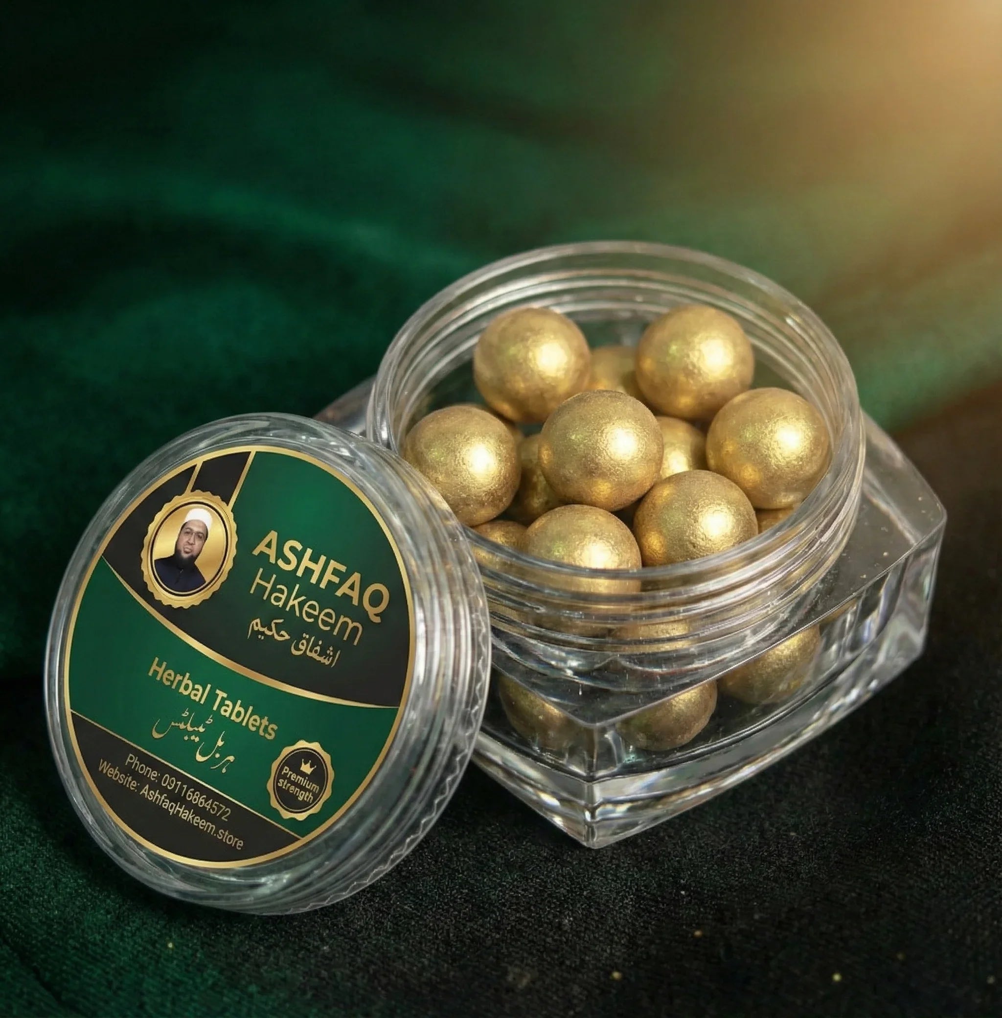 ASHFAQ Hakeem herbal tablets in a clear jar with gold-coated balls on a green background